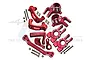 A set of red anodized aluminium RC car steering and hub components including steering knuckles, C-hubs, and hardware on a white background.