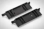 Two black plastic RGT RC chassis baffle plates shown from an angled top-down perspective on a white background.