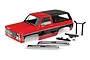 A red and black Traxxas TRX-4 1979 Chevrolet Blazer RC body shell with chrome bumpers and mounting hardware on a white background.