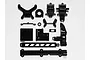A collection of black plastic RC car parts including gear case components and chassis braces laid out on a white background.