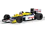 A 1/32 scale Scalextric model of the Williams FW11 Formula 1 car driven by Nigel Mansell, featuring the iconic yellow, blue, and white Canon livery.