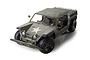 A 1/12 scale Tamiya XR311 RC military truck model painted in olive drab with a white star on the hood, featuring a driver figure and off-road tires.
