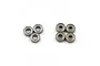 A set of seven small metal ball bearings arranged in two groups on a white background.