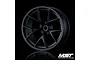 A single matte black MST RID RC wheel rim viewed from the front against a black background.