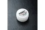 A small white plastic container of MST Ball Differential Grease, model 130040, sitting on a black textured surface.