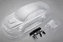 An unpainted clear polycarbonate RC car body shell for an E92 model, including a separate front bumper piece and black plastic accessories on a sprue.