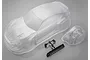 Clear unpainted 1/10 scale MST 86RB RC car body shell with separate bumper and black plastic wing parts on a grey background.