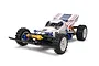 A studio shot of the Tamiya Boomerang 1/10 scale 4WD RC buggy, featuring a white body with blue and red racing decals and yellow shock absorbers.