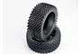 Two black rubber RC buggy tyres with a spiked tread pattern, stacked on top of each other against a white background.