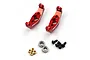 Two red anodized aluminium C-hub carriers for RC cars, accompanied by four small brass bushings, two ball bearings, and four black hex screws.