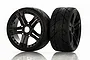 Two Jetko 1/8 scale Vertex ultra soft belted tyres mounted on black Claw rims, shown against a white background with reflections.