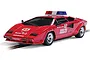 A red Scalextric 1/32 scale Lamborghini Countach 1983 Monaco GP safety car with a roof-mounted light bar, sitting on a slot car track.