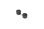 Two small, cylindrical black composite steering stops for RC vehicles against a white background.