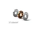 An exploded view of an XRAY ceramic ball bearing showing the inner race with black ceramic balls and two outer metal shields on a white background.