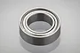 A single metal shielded ball bearing shown in a studio product shot against a light grey background.