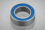 A single metal ball bearing with blue rubber seals on a light grey background.