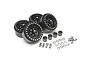 Set of four black Boom Racing 1.9 inch Venomous Krait beadlock rims with included wheel wideners, hardware, and accessories on a white background.
