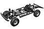 A high-angle studio shot of the Boom Racing BRX02 1/10 scale RC rock crawler chassis kit, showing the frame, drivetrain, suspension, and wheels.