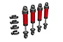 A set of four red aluminium GTM shock absorbers for Traxxas RC vehicles, shown with four black plastic spring preload spacers on a white background.