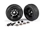 Two black Traxxas utility trailer wheels with tires, two wheel nuts, two axles, and four ball bearings on a white background.