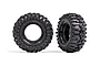 Two black Traxxas Mickey Thompson Baja Pro X RC crawler tyres shown from front and side angles against a white background.