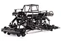 A studio shot of the Losi LMT TLR Tuned RC monster truck chassis kit, showing the carbon fiber frame, suspension, and drivetrain components.