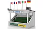 A Scalextric Classic Grandstand model with green seating, flags on top, and sponsor logos including Castrol and Dunlop.