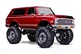 A red Traxxas TRX-4 1972 Chevrolet K5 Blazer High Trail Edition RC rock crawler on a white background.