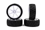Four Rush 1/10 scale RC touring car wheels with white seven-spoke rims and black radial tread rubber tyres.