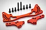 A set of red anodized aluminium RC car parts including a large shock brace and two smaller mounting plates with eight black steel screws.