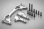 Rovan silver aluminium rear shock brace kit including three machined metal plates and a set of black steel screws on a grey background.