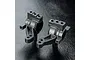 Two black plastic MST MB rear hubs for RC cars, shown from different angles on a textured black surface.