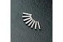 Eight small silver metal axle pins arranged in a fan shape on a textured black surface.