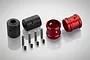 A set of Rovan RC drivetrain parts including two black bushings, two red aluminium bushings, four metal pins, and four small grub screws.