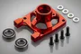 A red anodized aluminium clutch bell brace for RC cars, shown with two ball bearings, four silver washers, and four black hex screws on a grey background.