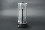 Koswork 1/8 scale vacuum pump and air removal tool for RC shock absorbers, featuring a clear cylindrical chamber on a black base.