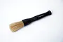 A Koswork branded round cleaning brush with a black textured handle and light brown bristles, isolated on a white background.