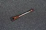 A brown metal Koswork turnbuckle wrench with 3.2mm and 5.5mm ends resting on a grey foam surface.