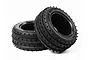 Two black Tamiya 2.2 inch Super Gripper front RC car tyres with a spiked tread pattern, shown against a white background.