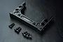 Black aluminium MST A D crossmember for RC chassis with included mounting screws on a black textured background.