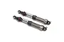 Two gunmetal grey aluminium RC shock absorbers with black plastic ends and silver springs, set against a white background.