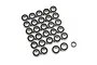 A collection of numerous small metal ball bearings with black rubber seals arranged on a white background.