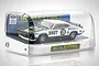 Scalextric 1/32 scale Ford XB Falcon GT slot car, number 33 Brut livery, inside its clear plastic display case on a white background.