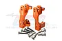 A pair of orange anodized aluminium steering hub carriers for RC cars, with included screws and metal bushings, displayed against a white background.