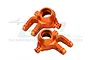 Two orange anodized aluminium steering hubs for RC cars, shown from a top-down perspective against a white background.