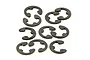 A collection of seven small dark grey metal E-clips arranged on a white background.
