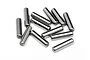 A collection of twelve small, cylindrical metal drive pins scattered on a white background.