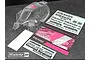 Clear Bittydesign Vision 1/8 scale RC buggy body shell with included decal sheets and promotional card on a dark surface.