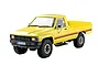 A 1/18 scale yellow FMS 1983 Toyota Hilux RC rock crawler truck viewed from a front three-quarter angle against a white background.