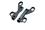 Two black anodized aluminium upper clamp parts for an RC car chassis, shown from an angled top-down perspective against a white background.